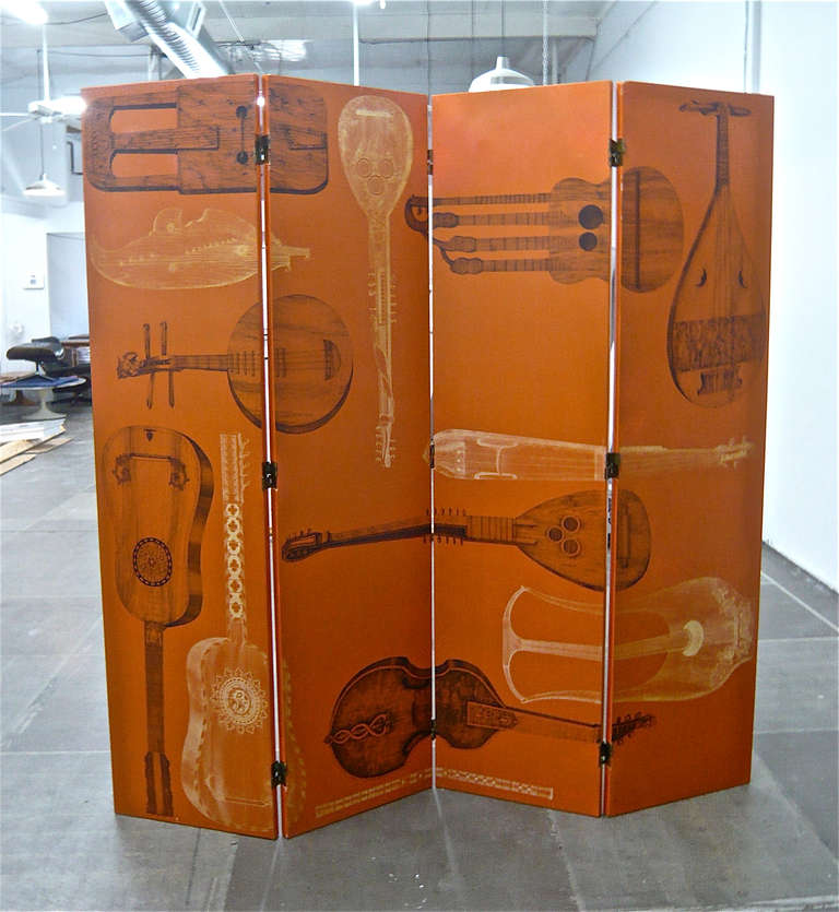 Double sided adjustable screen or room divider. Musical instruments on one side and op art on the other.