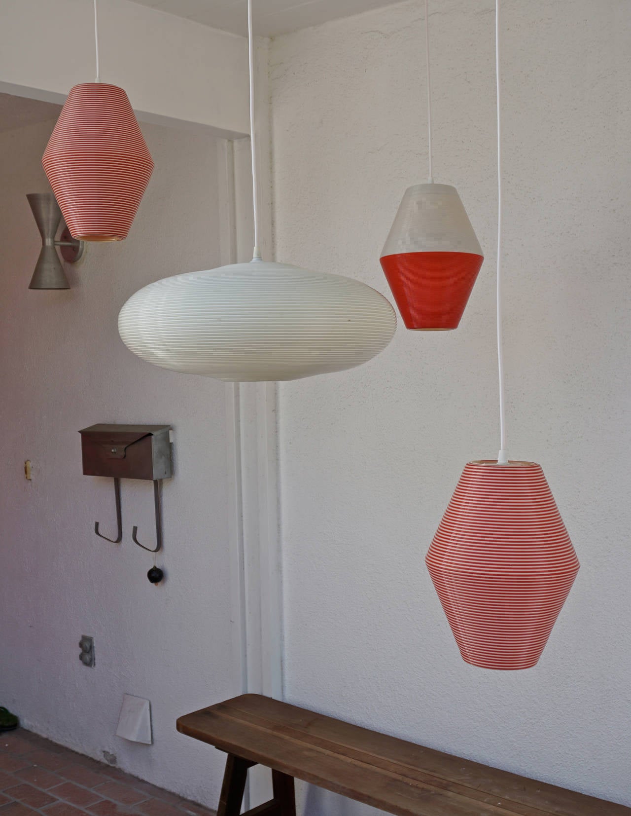 Ribbed plastic hanging lamps distributed in the US by Heifetz, imported from France. Designed by ARP (Atelier de Recherches Plastiques).
Pair of red and white striped lamps measure 12