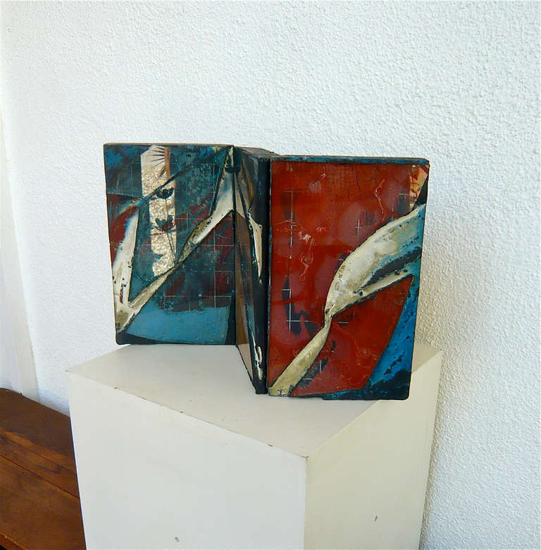 Known for his work in the 60's and 70's using organic materials,in this case,glass,cement,and colored oxides.This piece is on a much smaller scale than most of his other works,perhaps a maquette for something larger.it is hinged on one side which