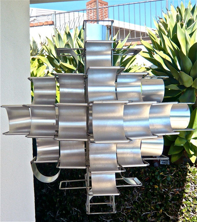 HANGING PENDANT LAMP. DRAMATIC MIXTURE OF LIGHT AND PATTERNS FROM ALUMINUM REFLECTORS.