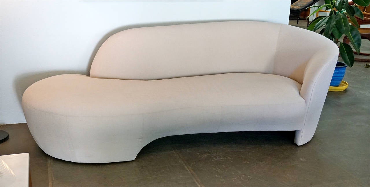 Beautiful, elegant sofa upholstered in off white fabric.