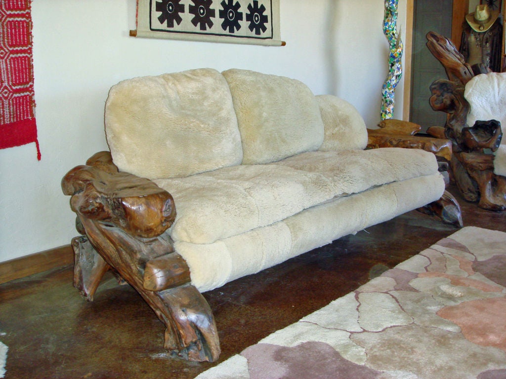 This hard to find sofa should be seen form all sides. In its current placement, the natural beauty of the back is hidden. Down filled natural sheepskin cushions provide maximum comfort.