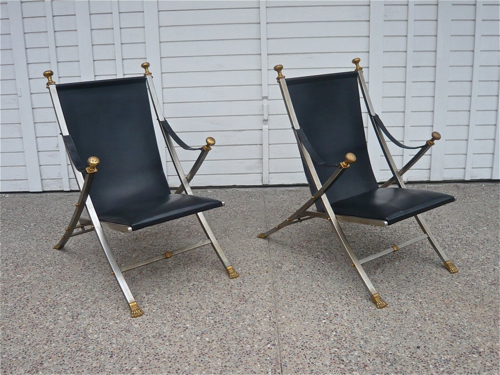 Matching pair of folding campaign chairs in excellent original condition by Maison Jansen,a French company started in the late 1800's who's client list included the White House.