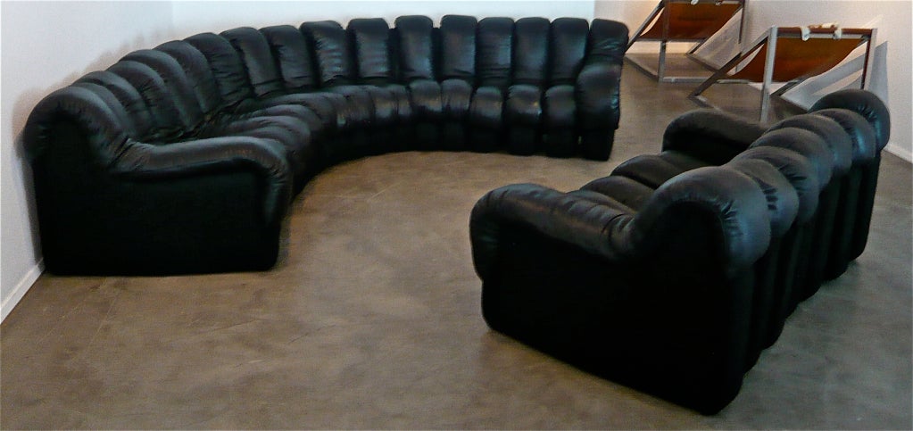 17 section sofa and 7 section loveseat,zippered and hinged together to offer accordion like movement that allows for various arrangements.Soft quality black leather over foam rubber for maximum comfort.
Sofa dimensions are 204