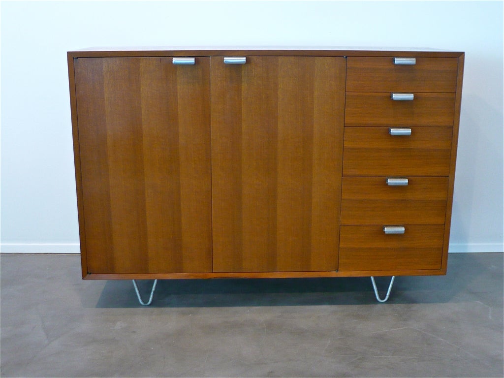 Classic pair of tall dressers in Chile walnut with j-pulls and hairpin legs.
One retains H. Miller foil label.