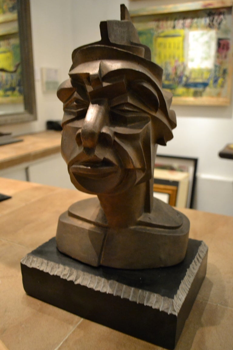 A striking abstract bronze bust that is bound to capture your attention no matter what direction you might view it from.  Created by California sculptor Matt Harvey who cast this original cubist style bust of a male in bronze.  The sculpture sits