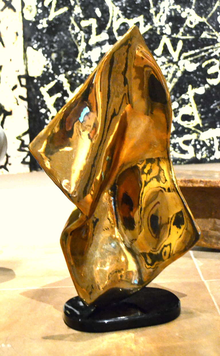 No matter which direction this sculpture is resting, you see something completely different. Standing 18.5 inches high and signed by the artist. The sculpture sits upon what appears as black marble base, but instead is laminate.