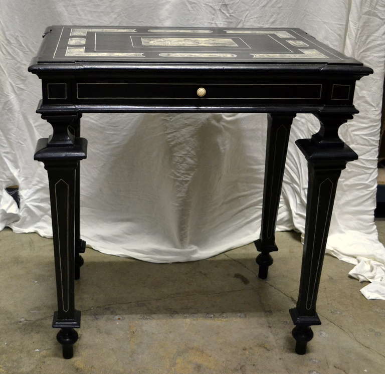 Italian desk or side table of century XIX, the region of Piedmont, in ebonized  wood decorated with bone chiseled to plumilla and inlaid filetajes, in decorated forms and borders, their totality. Drawer in the frontal.  Makers Mark. Pogliani