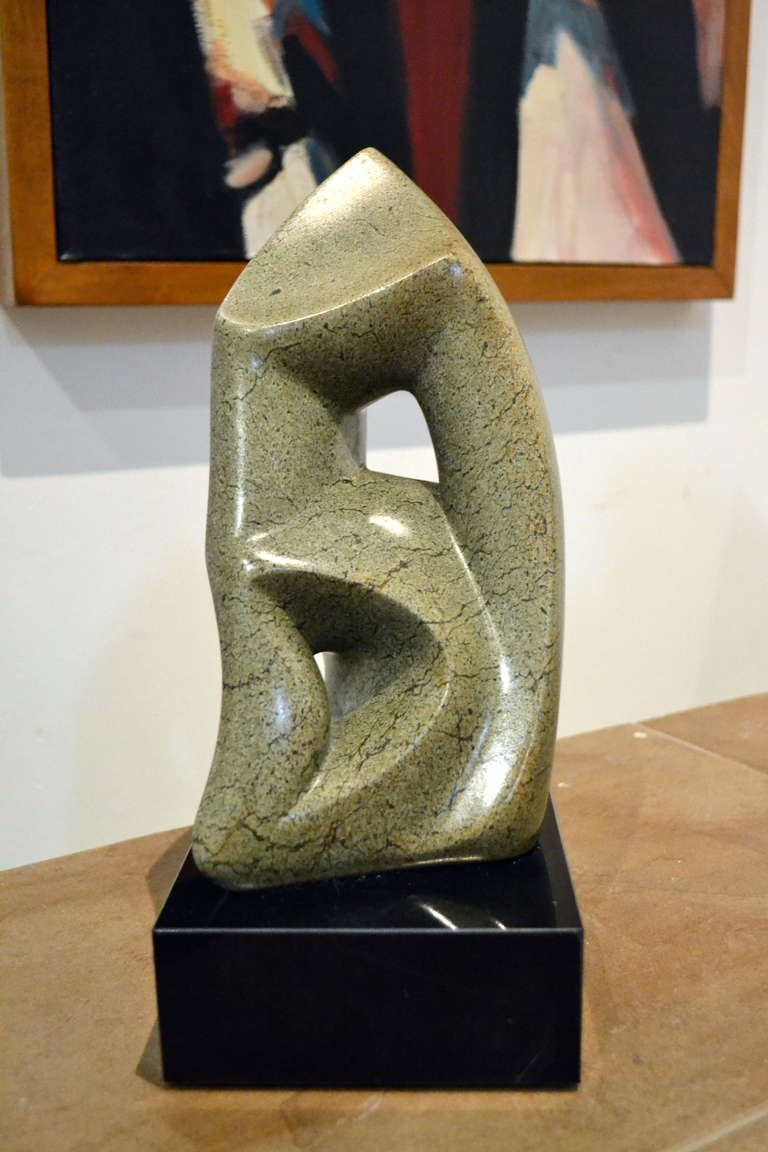 Titled EMERGENCE, this abstract serpentine sculpture is by artist Doug Butler. It is signed at the base and it sits on a black marble base.  A perfect addition no matter where it sits as it commands attention.