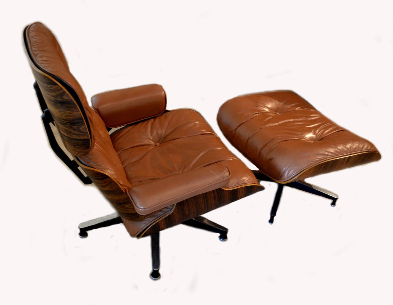 Like anything Classic, this Eames lounge chair and ottoman (circa 1973) by renowned furniture maker Herman Miller gets better with age. Both are hand-assembled with great attention to detail. The shells are 7-ply rosewood veneer and the cushions are