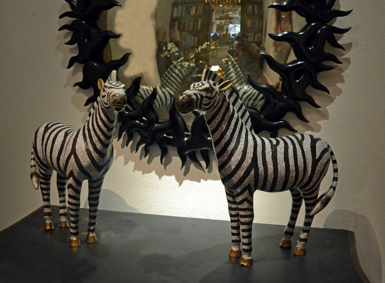 Pair of large cloisonné enamel over gilded bronze zebra sculptures. Black and white enamel striped design throughout, mid to late 20th century.

Measuring 22