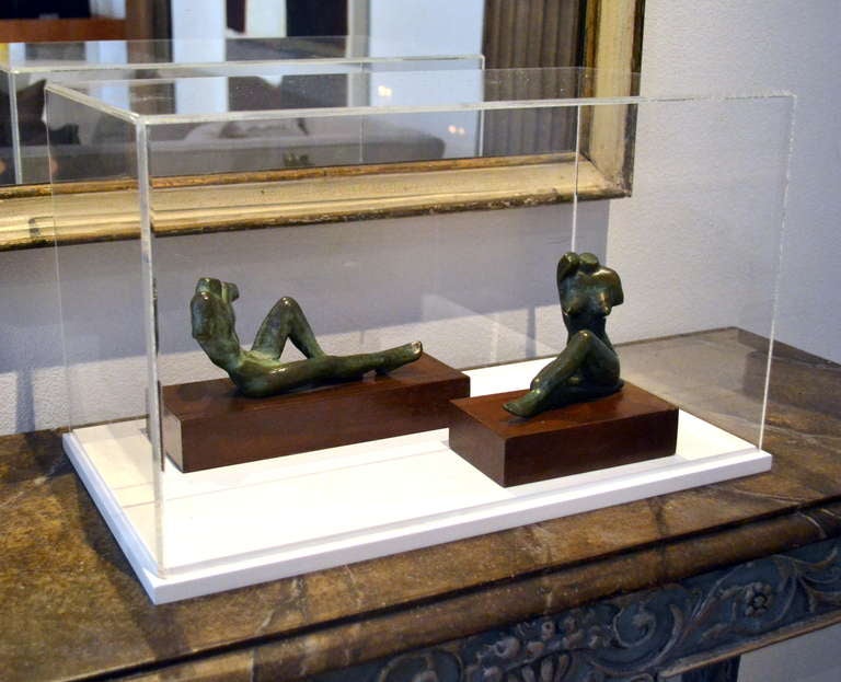 Olivia Guzmán (Mexican, 20th century) created these original bronze figures and mounted them to a wood base. Each torso has an amazing bronze patina and are in perfect condition. Dimensions: The male figure is 3.5 inches high X 7.5 inches wide and