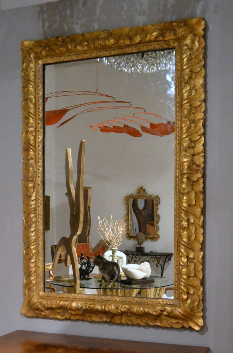 Carved wood, gesso and gilt Italian Mirror with a design of large-leafed overlapping foliage.