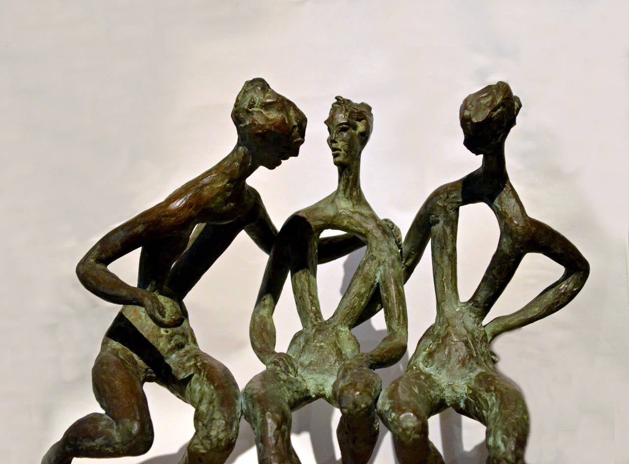Exceptional, striking and elegant are but a few adjectives that appropriately describes this abstract bronze sculpture of three female figures 15 inches tall that are suspended in a seated position above a unfilled travertine marble