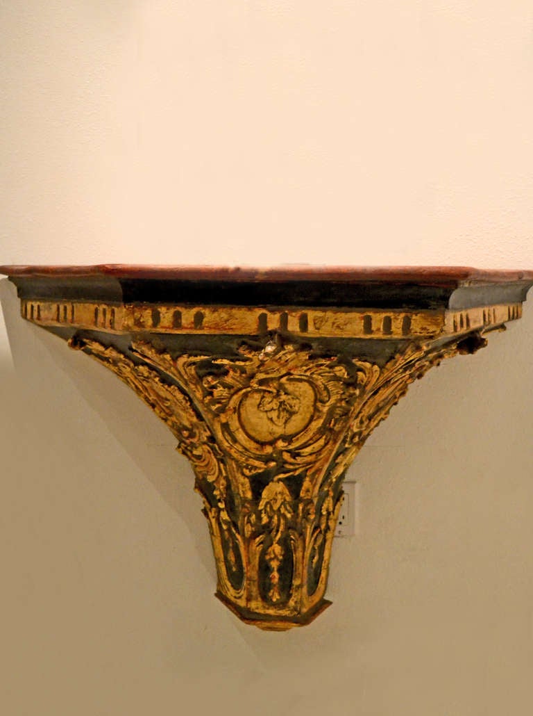 Large gilt wood and polychrome carved shelf or table dating back to a relic in a Spanish church during the reign of Louis the XV.  Presented as a console table today.  A fresh faux marble top adds a cleaner authentic and esthetic appeal.