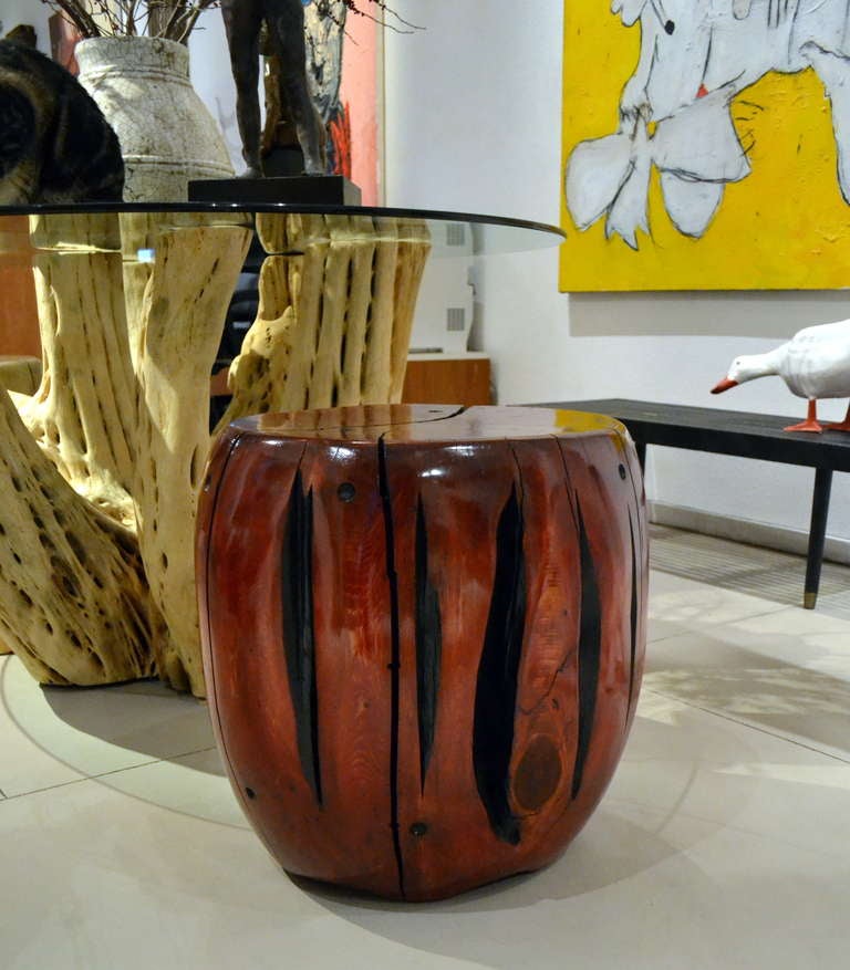 Artist Daniel Pollock (b.1952), takes found wood from the San Bernardino National Forest and refinishes and reshapes it to create this strikingly handsome and one of a kind red cedar table or seat. Signed and dated on the underside.