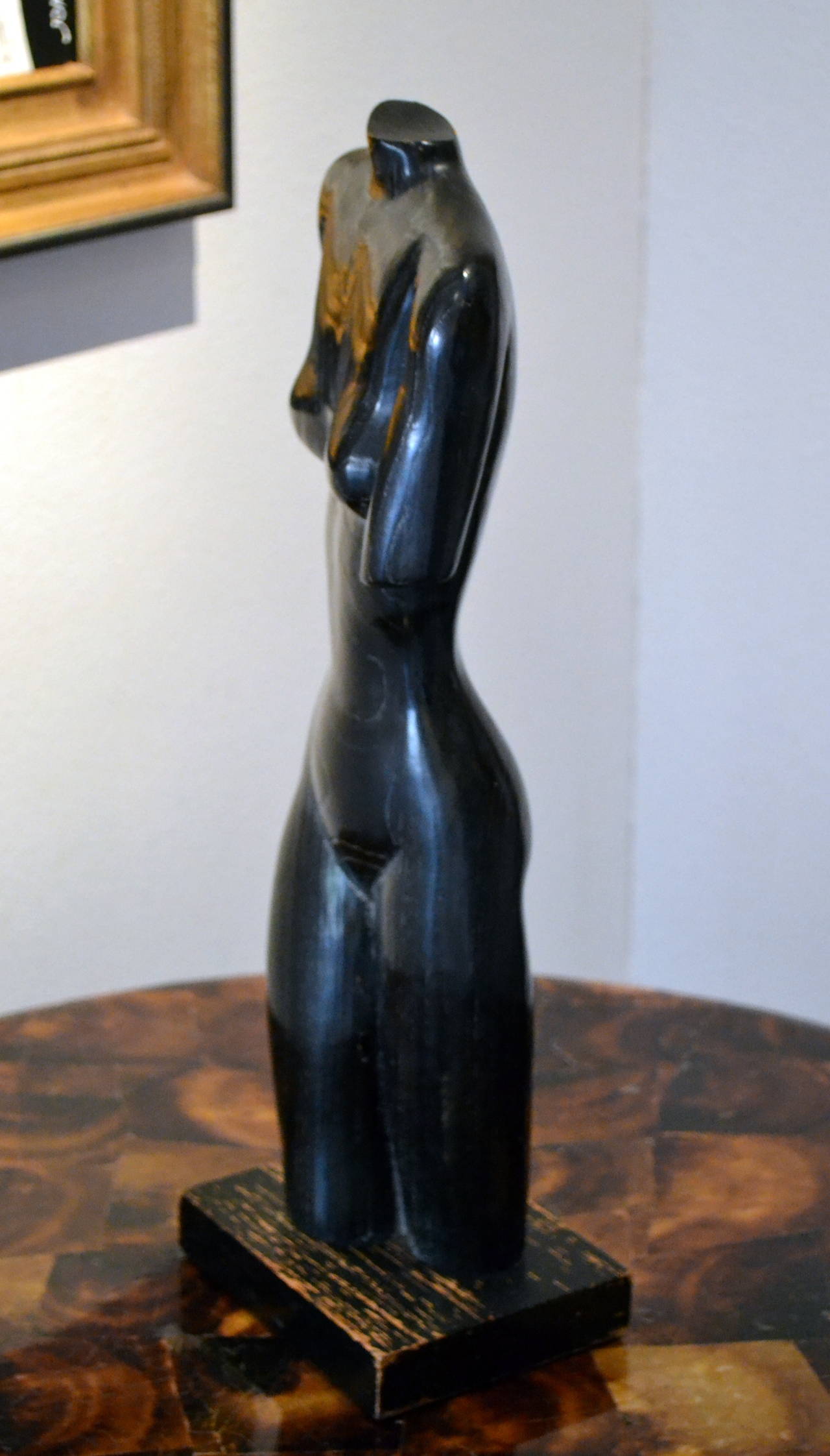 Artist Edward Armen Stasack (b. 1929) created this elegant Modernist 
nude sculpture from black limed Oak wood.  The figure is elegantly carved and grain of the wood adds tremendous character to the art work.  Overall the sculpture reads sleek,