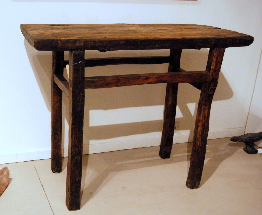 Wooden pegs and dovetail joints keep the construction of this early hand carved primitive wood table in perfect harmony.  Console or alter height measuring 33 3/4