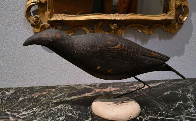 Charles Perdew (1874-1963) was considered the greatest wood carver in America, especially when it came to carving a crow decoy.  He constructed his carvings by using two pieces of wood, painting them and then inserting two iron legs.  His crows were