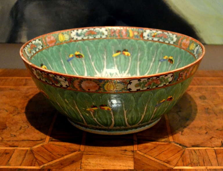 A Chinese Export Canton Famille Verte cabbage leaf punch bowl decorated throughout with cabbage leaves, hovering butterflies and reserve panels depicting scrolling flowers. Otherwise known as a Chinese Bokchoy Patterned Porcelain Bowl,  

The
