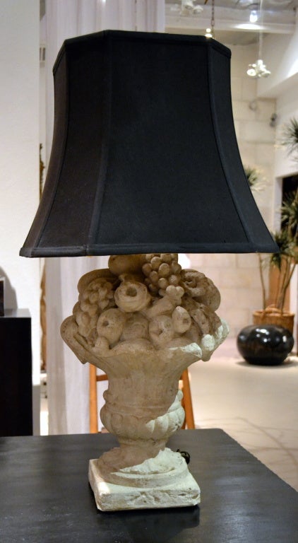 Wonderfully classic cast stone fruit basket  fitted as a table lamp for 110 v. use.   Lamp measures 21: high and with shade the overall height is 33