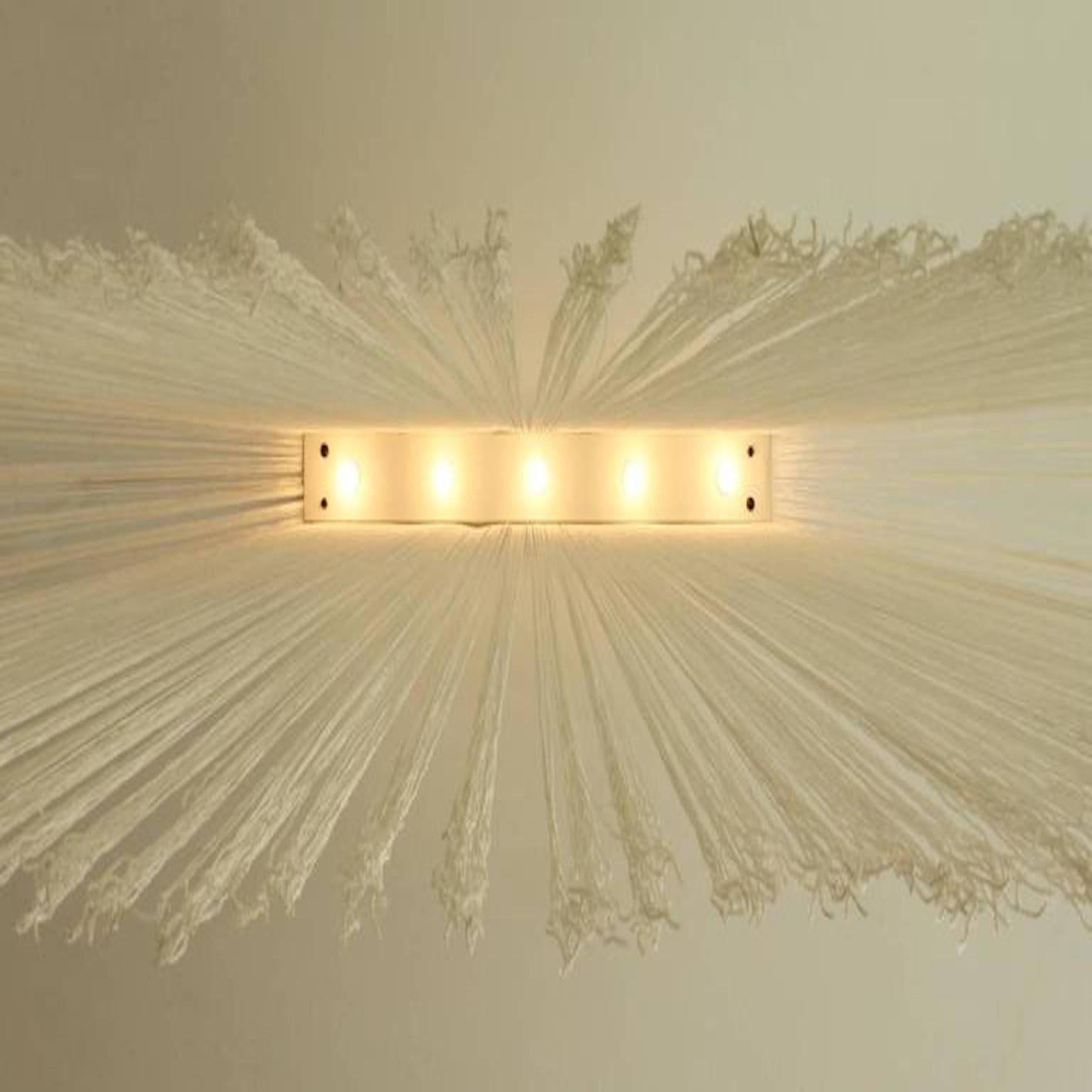 Garbo ceiling lamp designed in 1976 by Mariyo Yagi and Studio Simon for Sirrah, Italy. Metal lacquered structure with five bulbs that supports a curtain of nylon fabric rope. 

The piece can be used singularly as soft light on the walls or as a