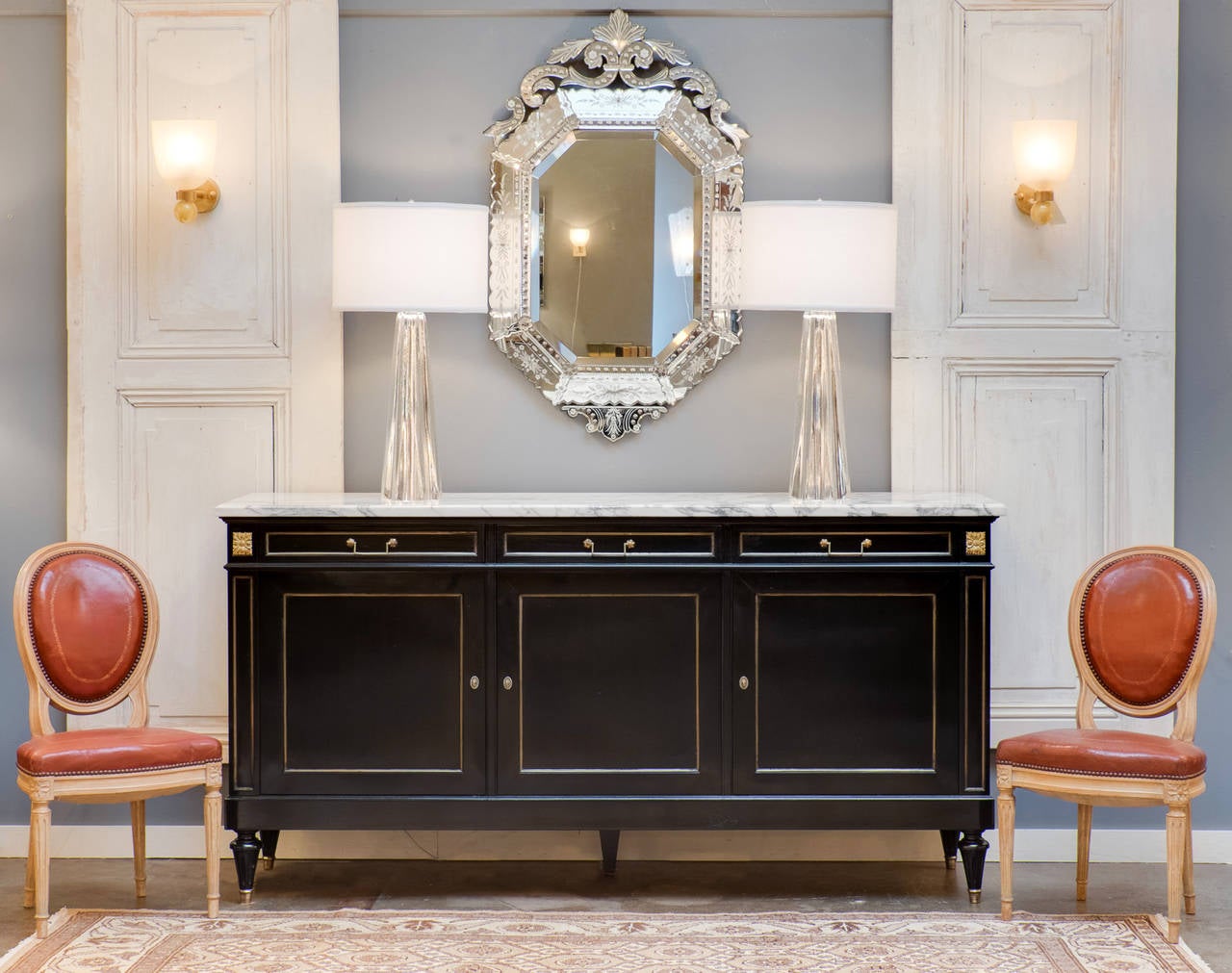 French Louis XVI style buffet in ebonized mahogany, finished with a lustrous French polish, and topped with its original Carrara marble slab beautifully veined and unusually thick . Three doors and three dovetailed drawers trimmed in brass, 