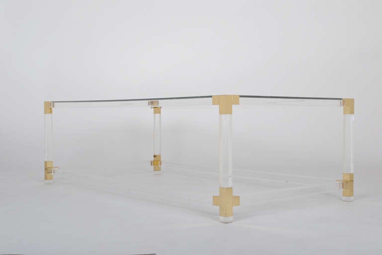 French vintage lucite and brass cocktail table with clear glass shelves, lucite square sections, and brass couplings. Very elegant and classic piece.
