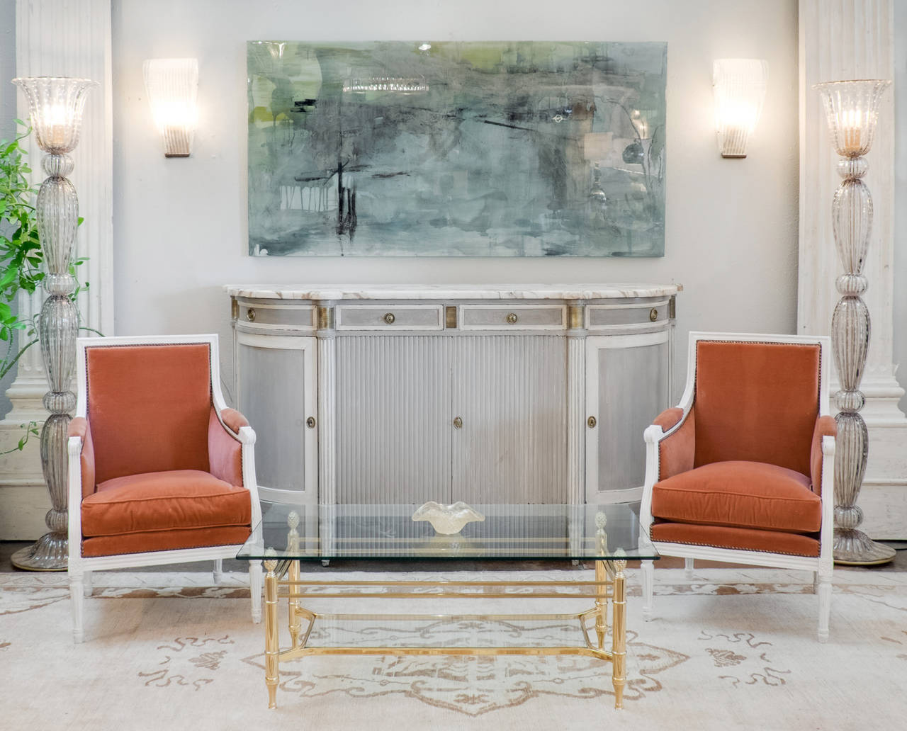 French antique, Louis XVI style buffet of solid mahogany with Trianon gray and white patina, hand-carved fluting, decorative bronzes and a striking brêche marble slab top. Four dovetailed drawers and four doors with adjustable interior shelves. We