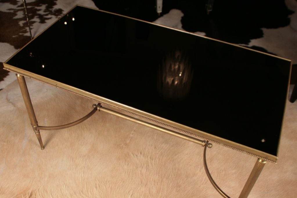 Beautiful French Art Deco period Neoclassic coffee table in brass and black opaline glass, all original. Maison Charles.