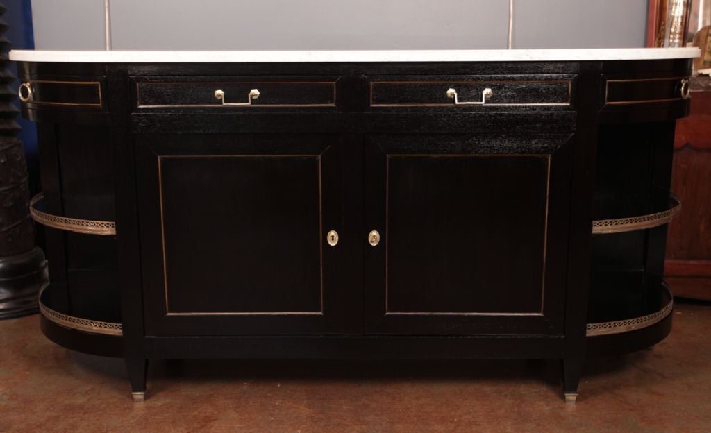 Spectacular French antique Louis XVI style buffet in solid ebonized mahogany, brass trims, opened brass galleries, veined Carrara marble top, tapered legs. Great construction quality, solid oak as secondary wood. Wonderful classic investment.