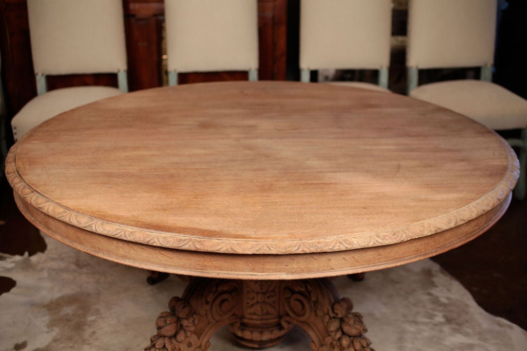 Beautiful French antique Renaissance style dining table in solid hand carved and bleached oak. Decor of Acanthus leaves, floral and pomegranate.