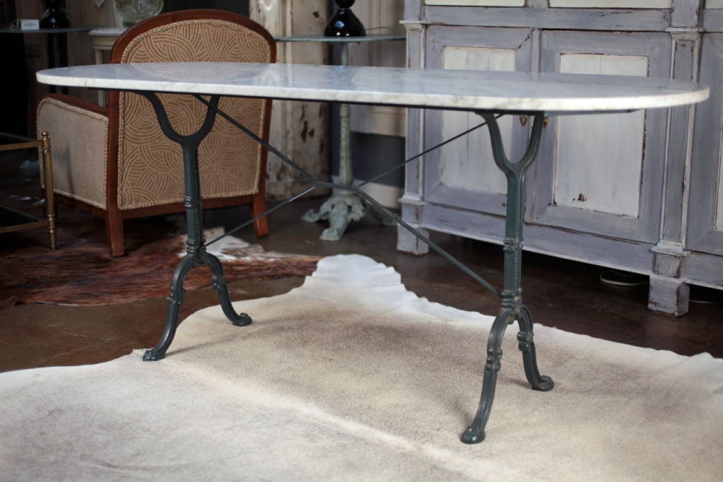 Fabulous French antique bistro table with Carrara marble top and cast iron base signed by Godin.