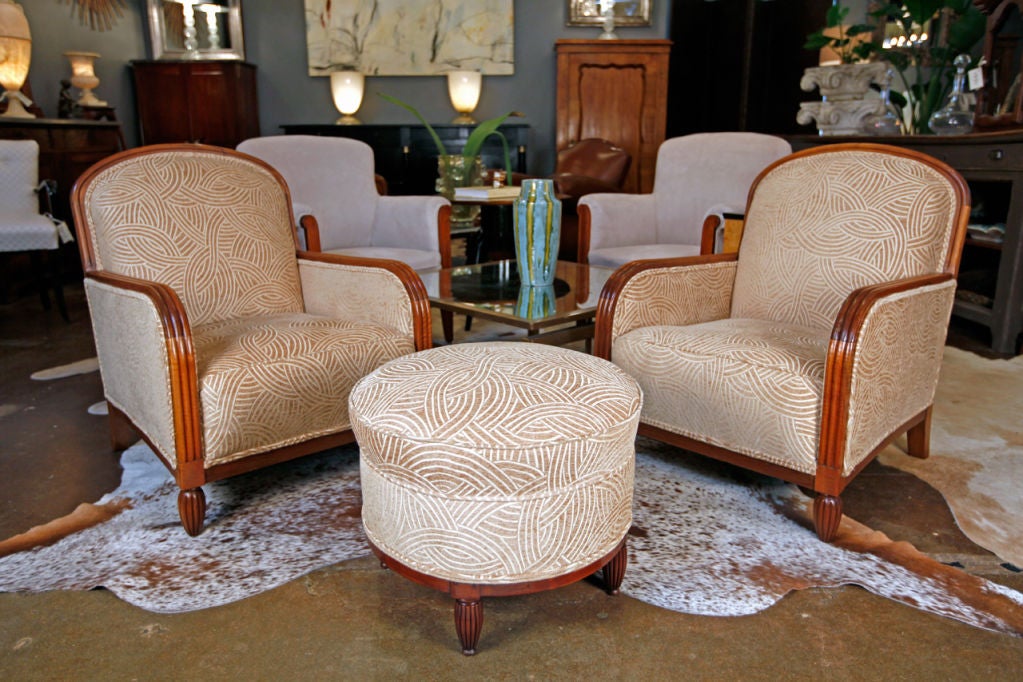 Wonderful French Art Deco period ottoman in the Ruhlmann style.  Solid blonde walnut with hand carved  fluting details, newly reupholstered. French polished  walnut<br />
Matching pair of armchairs also available.
