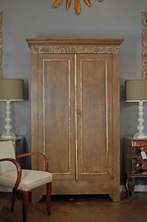 Beautiful French antique painted armoire in solid pine from Provence. Gold-leafed accents and Greek key motif on top traverse. Very elegant neoclassical piece with wonderful storage.