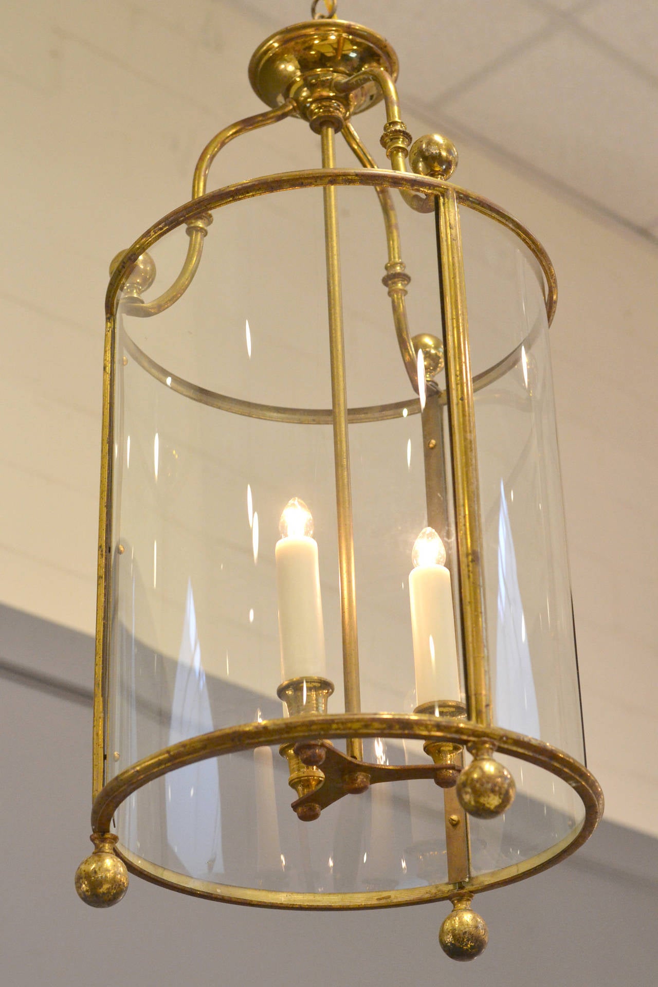 French antique lantern in brass and glass, electrified with a three candelabrum cluster, rewired for the US. Height with included chain and canopy is 50 in.