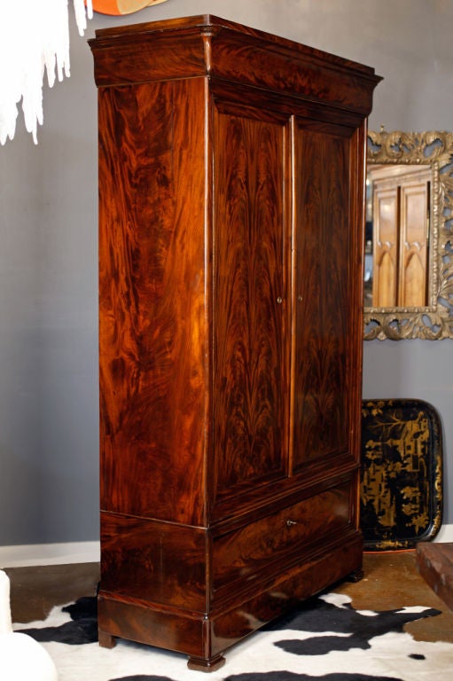 Elegant early 19th-century mahogany armoire with striking Cuban flamed mahogany. From French Burgundy.<br />
22