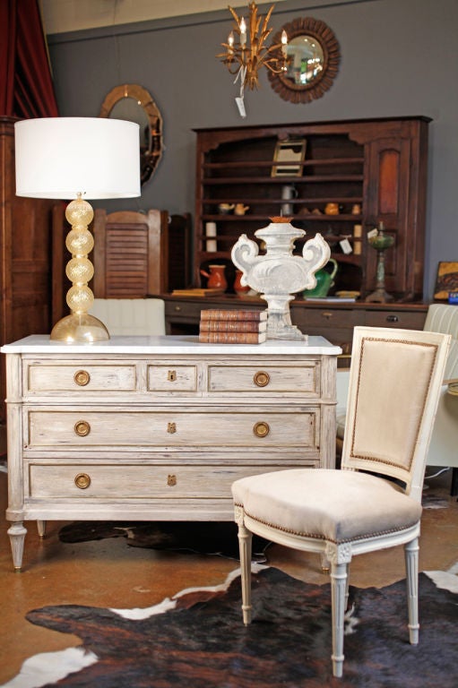 Comfortable set of six Louis XVI chairs. Original pearl-colored velvet in good condition. Beautiful carved details on the legs (fluting, rosace...)
