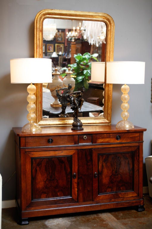 Elegant French antique mercury glass mirror. 23 carat gold leaf with Greek key design and beading detail on frame. Beautiful sienna colored hues coming through the gold leaf.