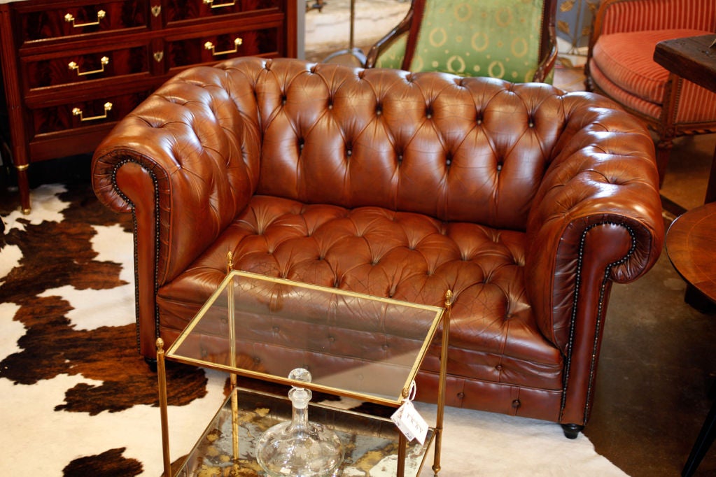 Superb Havana colored leather Chesterfield from England. Very comfortable, leather is very strong and has a great patina.