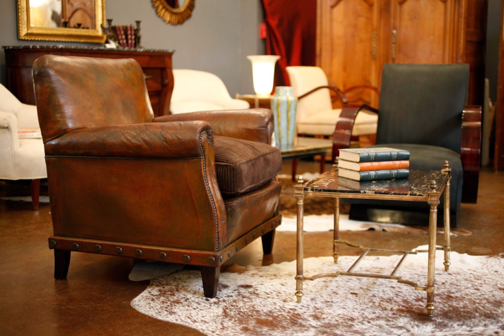 English pair of club chairs in original leather, brown with bronze patina, down velvet cushions.