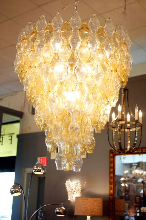 Each piece of clear and amber glass was individually hand blown by Murano artisans to create this stunning five-tiered chandelier. The unique shape and texture make it the perfect statement piece. (Rewired to US standards.)