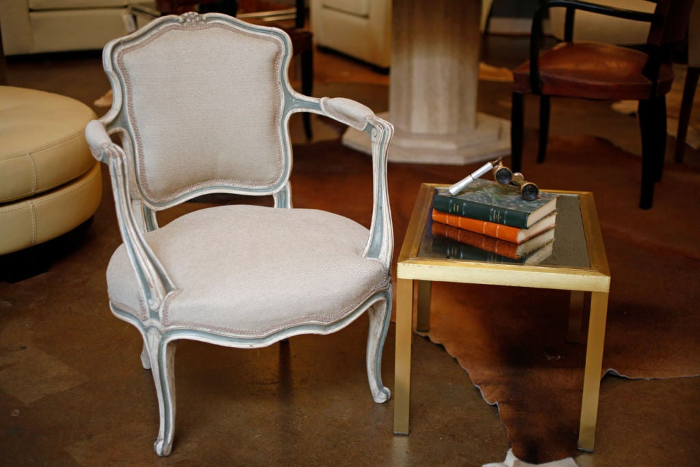 Petite Louis XV style hand painted armchair, newly reupholstered in a linen blend. Beautiful hand carved details over entire frame. Beautiful original paint ivory and blue.