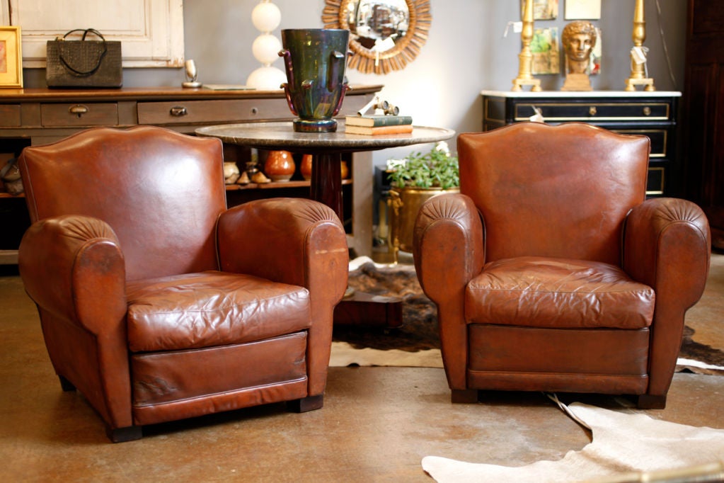 Beautiful classic French pair of moustache club chairs in original lambskin leather, with brass nail heads and beautiful ruched detail on arms. Comfortable and fully reconditioned these are the best we have found in quite a while.