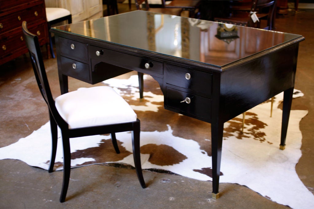 French Louis XVI style mahogany desk, ebonized and French polished, with five drawers, patined brass hardware, and tapered legs. Great proportion and construction quality.