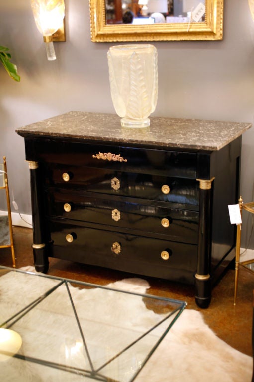 French Empire period mahogany chest of drawers, ebonized and French polished, full detached columns. St. Anne marble top and original finely cast bronze hardware with swan motifs. A beautiful piece with perfect proportions and such a great size.