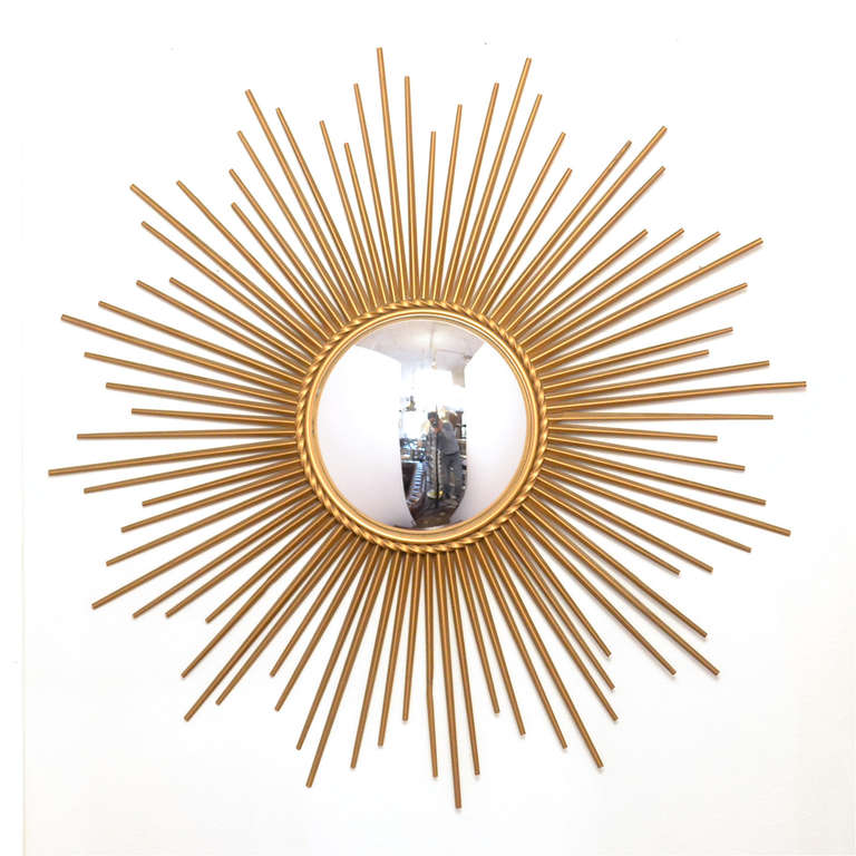 French vintage sunburst mirror in brass with a braided ring around the original convex mirror.