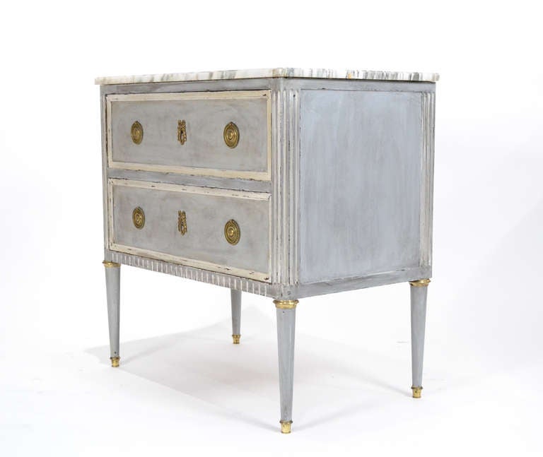 French Louis XVI style chest of drawers of solid cherrywood, oak as secondary wood, with intact Carrara marble top, fluting, brass hardware & feet. Beautiful grey/blue patined finish. Great lines and strong craftsmanship.