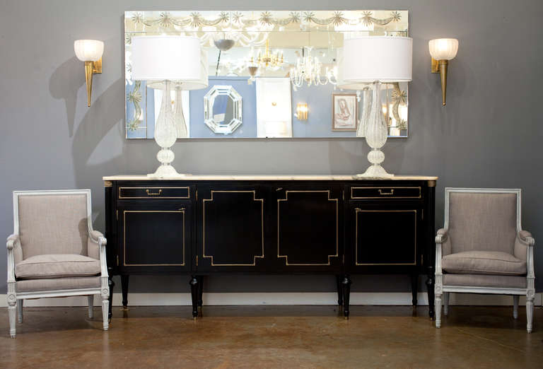 Vintage Louis XVI style ebonized buffet from France. Carrara marble top grey veins with light coral hues, bronze trim, and a glossy French polish finish. Two dovetailed drawers and four doors with interior shelves. Great craftsmanship, lots of