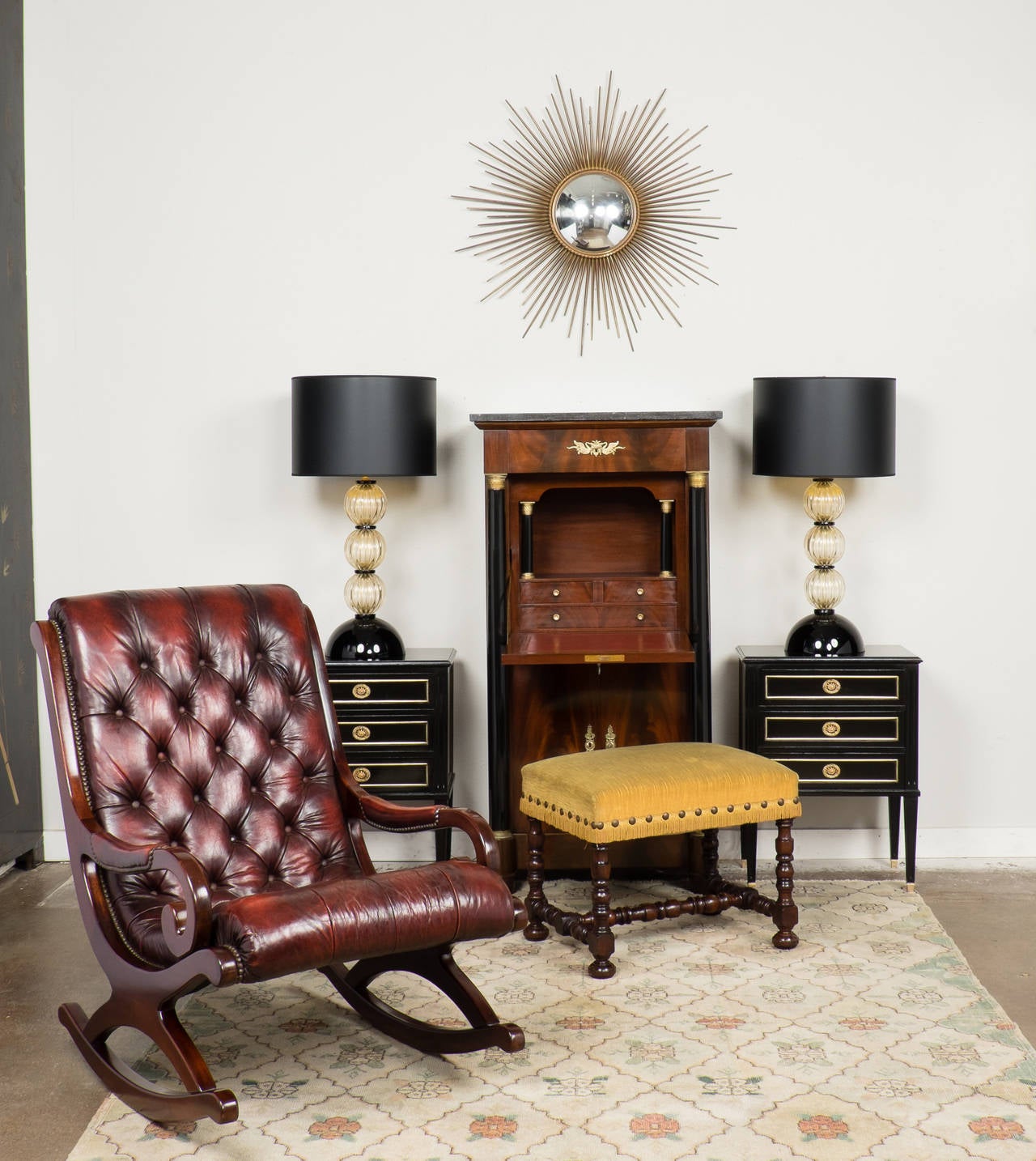 Supremely comfortable and incredibly handsome vintage rocking chair from France, circa 1940s. Gorgeous tufted mahogany red patinated leather with brass upholstery tacks, on a solid mahogany frame, finished with a lustrous French polish. Tons of